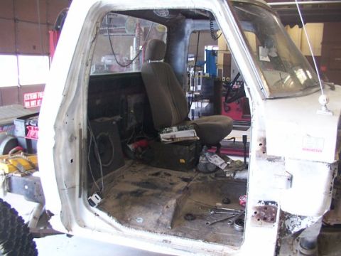 1978 Ford Bronco - Pickup truck interior during a build, showing the driver's seat and floor area.