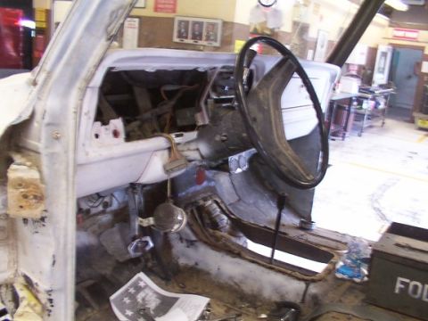 1978 Ford Bronco - The interior of a vehicle is shown in a state of disassembly, with exposed wiring and a removed dashboard.
