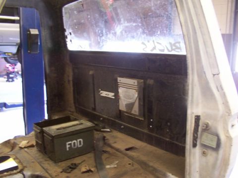 1978 Ford Bronco - Interior of a vehicle, possibly undergoing restoration, with a toolbox and visible paneling.