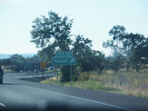 2001 Mercury Grand Marquis - A highway scene shows an exit sign for Talent, Exit 21, with trees and a blue sky in the background.