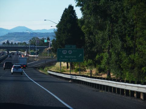 2001 Mercury Grand Marquis - Driving on the highway with multiple vehicles and directional signs visible.