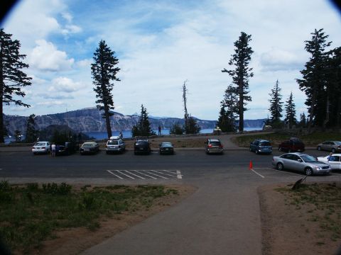 2001 Mercury Grand Marquis - A scenic overlook parking area with multiple vehicles and a vast landscape of water and mountains.