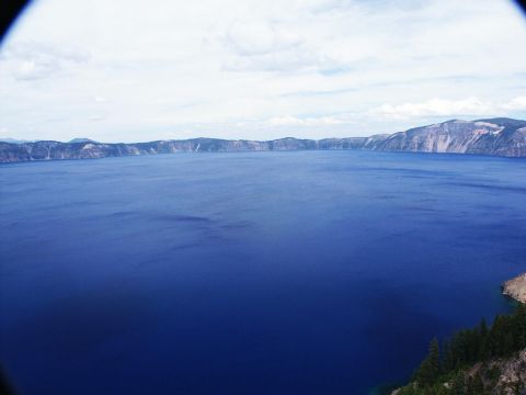 2001 Mercury Grand Marquis - View of Crater Lake, Oregon, showing the vast blue water and surrounding caldera rim.