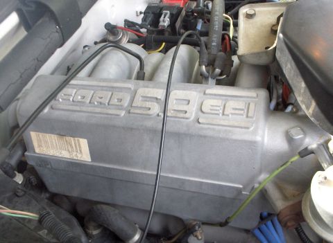 1993 Ford Bronco - Close-up of a Ford 5.8 EFI engine intake manifold, showing engine details and a barcode.