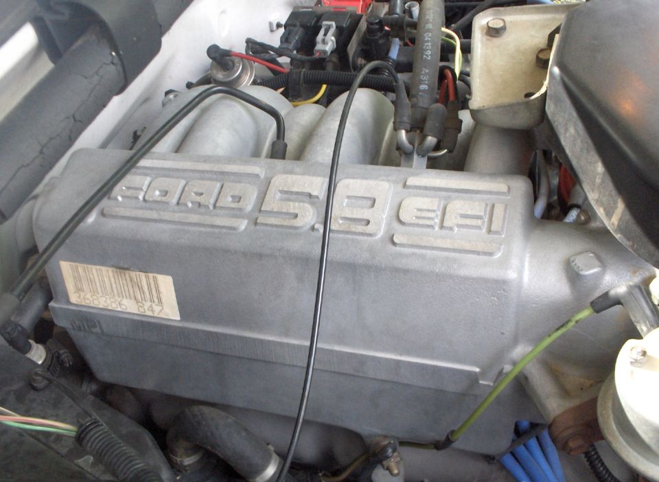 Silver Ford 5.8 EFI intake manifold with a barcode sticker