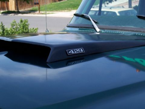 1972 Ford Ranchero - Hood scoop with 429 badge on a dark green vehicle.