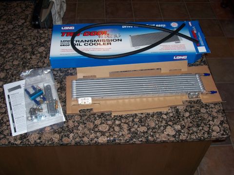 2002 Ford Mustang - A new transmission oil cooler kit is shown, including the cooler, hoses, and mounting hardware.