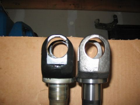 1995 Ford Bronco - Comparison of two clevis-ended shafts, one modified with black coating.