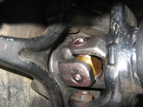 1995 Ford Bronco - This image shows a close-up view of a vehicle's driveshaft universal joint, highlighting its components.