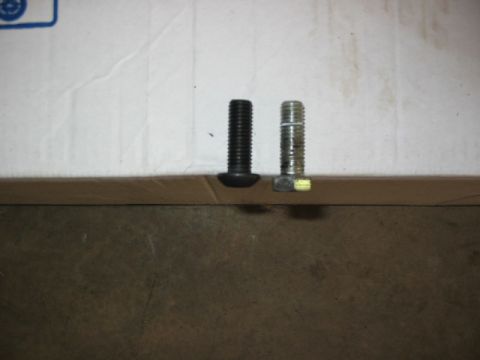1995 Ford Bronco - Two bolts are shown side-by-side on a flat surface.
