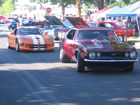 1989 Ford Mustang - A maroon 1969 Camaro SS and an orange Dodge Viper are seen at an outdoor car show.