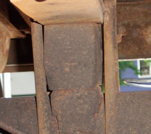 1979 Ford F-250 - Close-up view of rusty truck frame and suspension bump stop.