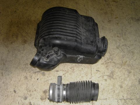1995 Jeep YJ - This image shows a black air intake box and a flexible hose, likely for a vehicle's engine.