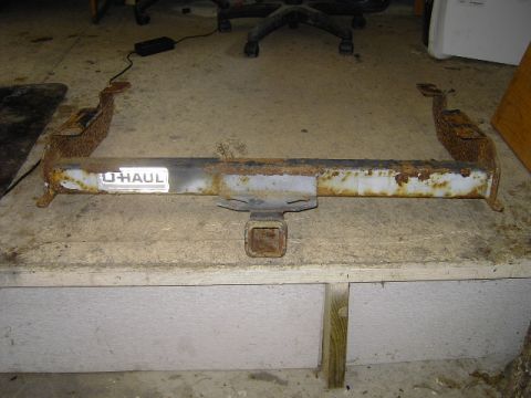 1995 Jeep YJ - This rusty trailer hitch, bearing a U-Haul label, is presented for identification. No vehicle year is discernible from the part itself.