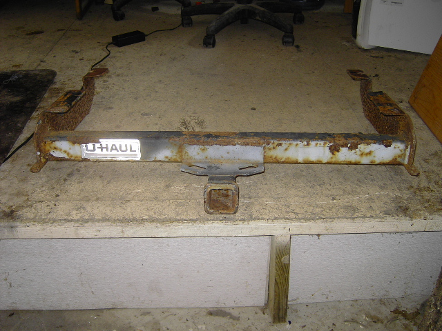Rusty trailer hitch with U-Haul label