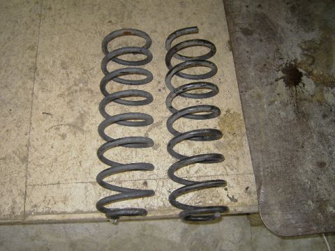 1995 Jeep YJ - Two coil springs are shown, likely for a vehicle's suspension system.