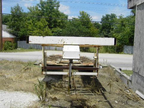1995 Jeep YJ - A weathered trailer sits abandoned on a dry, overgrown lot.