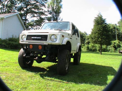 1977 Ford F-250 - This white Suzuki Samurai features off-road modifications, including a custom bumper and raised suspension.