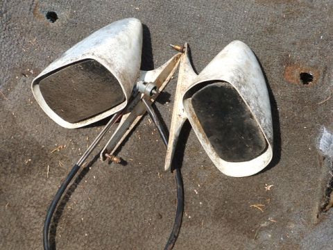 1966 Ford Ranchero - A pair of vintage side mirrors are shown, detached from a vehicle and resting on a carpeted surface.