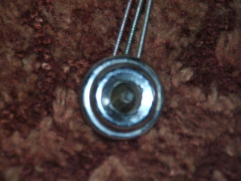 1966 Ford Ranchero - Close-up of a chrome knob with three cables attached, set against a textured background.