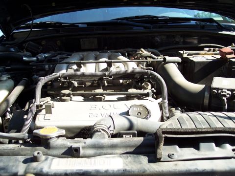 1995 Ford Probe - Close-up of a car's engine bay, showing the engine cover and oil cap.