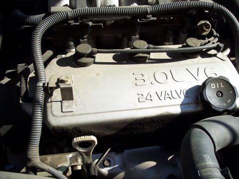 1995 Ford Probe - The engine bay shows a 3.0L V6 24-valve engine with an oil cap and dipstick clearly visible.