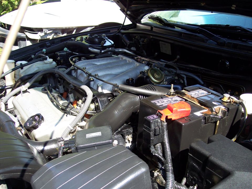 Engine bay with battery and intake manifold visible