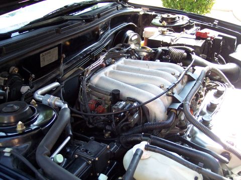 1995 Ford Probe - Close-up view of a car's engine bay, showing the intake manifold and various components.