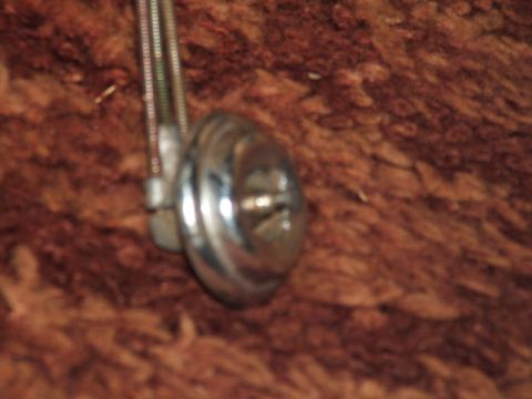 1966 Ford Ranchero - A close-up shot shows a chrome knob connected to a cable, set against a textured surface.