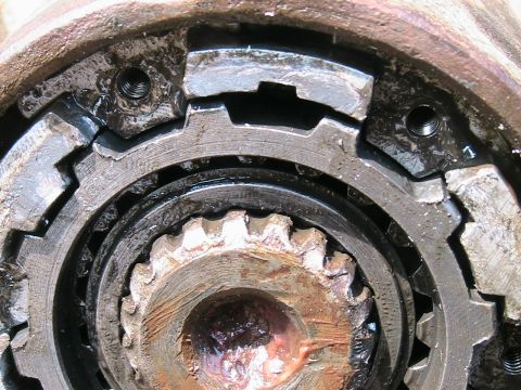 1977 Ford F-250 - A detailed view of a worn and greasy hub assembly, showing its internal mechanical components.
