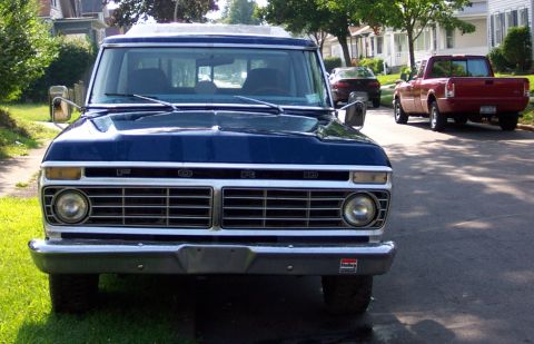 1975 Ford F-150 - Front view of a blue 1975 Ford F-150, with a red Ford Ranger in the background.