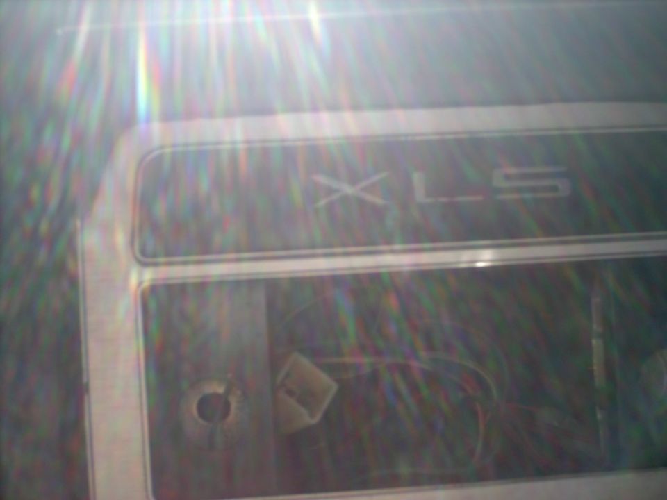 Interior trim panel with 'XLS' badge and visible wiring