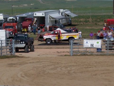 1972 Ford Ranchero - Several trucks and trailers are gathered at an outdoor event, possibly a competition or show.