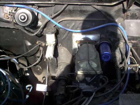 1982 Ford Bronco - Close-up view of engine bay components including brake system parts and a blue filter.