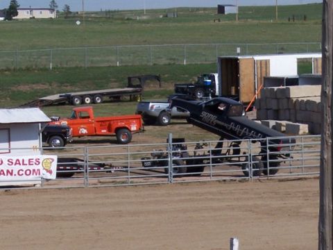 1972 Ford Ranchero - A modified pickup truck is loaded onto a trailer at an outdoor event.