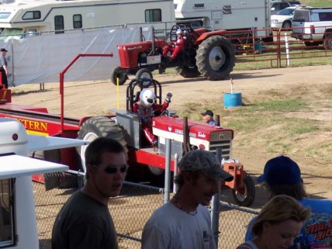 1972 Ford Ranchero - Tractor pull event with drivers in racing gear and spectators watching the foreground.