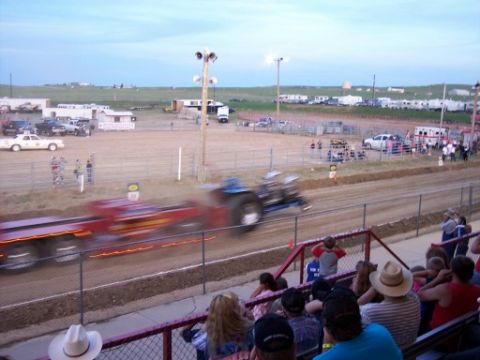 1972 Ford Ranchero - A tractor competes in a pull event, with a crowd watching from the stands.