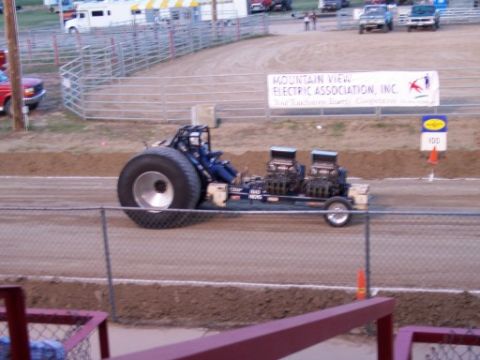1972 Ford Ranchero - A custom tractor pull vehicle with dual engines and massive rear tires competes on a dirt track.