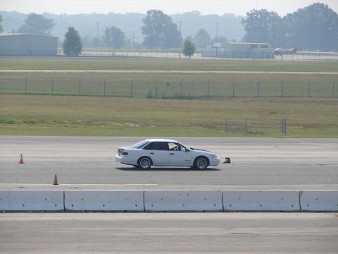1992 Ford Taurus - White 1992 Ford Taurus seen on a race track during an event.