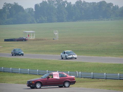 1992 Ford Taurus - Multiple vehicles on a race track during an event.