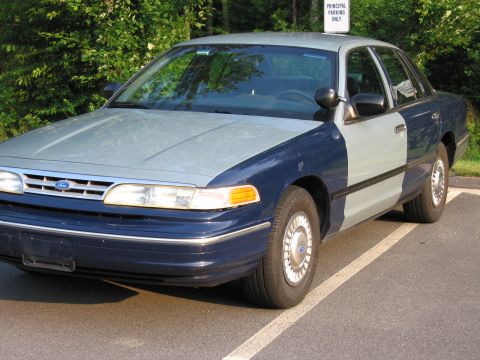1991 Ford LTD Crown Victoria - This 1991 Ford Crown Victoria features a two-tone paint scheme and is parked in a designated spot.