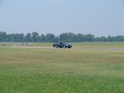 1992 Ford Taurus - A 1992 Ford Taurus navigates a turn on a sunny day at the racetrack.