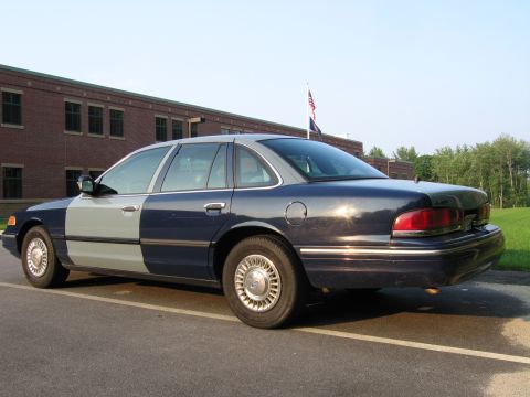 1991 Ford LTD Crown Victoria - This 1991 Ford Crown Victoria LTD features a distinctive two-tone paint scheme, with the front half in gray and the rear in dark blue.
