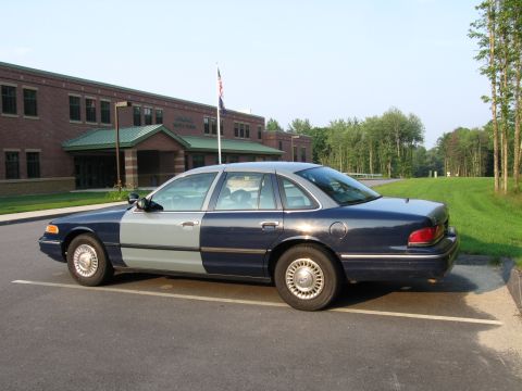 1991 Ford LTD Crown Victoria - Side view of a 1991 Ford Crown Victoria LTD with a two-tone paint job parked in a lot.