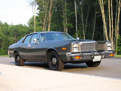 1991 Ford LTD Crown Victoria - This 1977 Dodge Monaco sedan features a distinctive grille and chrome accents, seen from a three-quarter front angle.