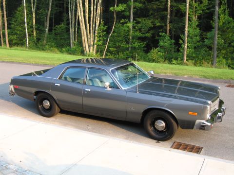 1991 Ford LTD Crown Victoria - This 1977 Dodge Monaco sedan is seen from a 3q front angle, parked on a roadside.