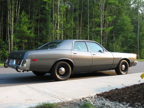1991 Ford LTD Crown Victoria - This 1977 Dodge Coronet sedan features a two-tone paint scheme and police-style wheels, seen from the side.