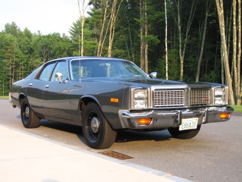 1991 Ford LTD Crown Victoria - This 1977 Dodge Monaco sedan is parked on the side of a road with a wooded area behind it.
