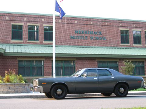 1991 Ford LTD Crown Victoria - A 1977 Dodge Monaco sedan is parked in front of Merrimack Middle School.