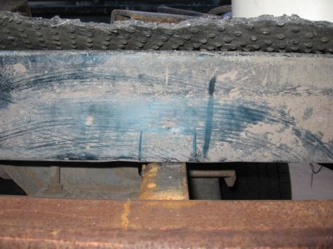 1974 Ford F-100 - Close-up of a vehicle's rear bumper and frame, showing wear and tear.